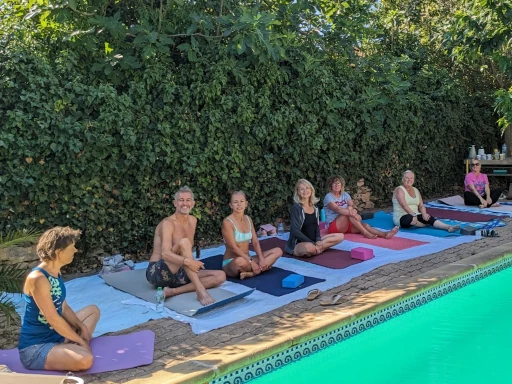 Guided meditation group by pool